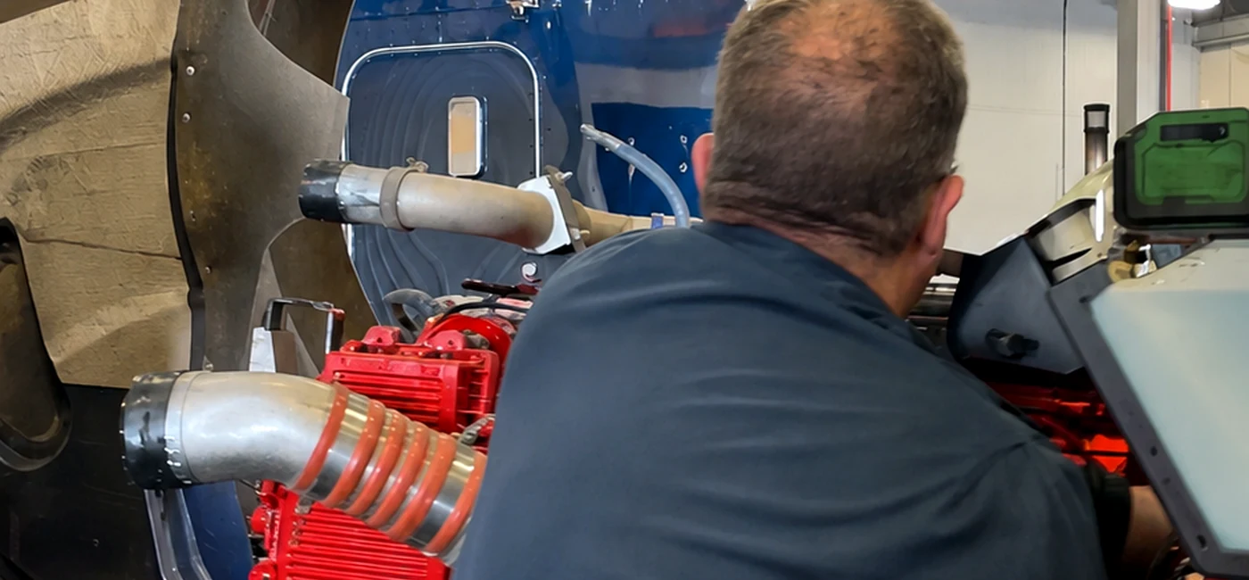 Technician working on a heavy-duty truck engine